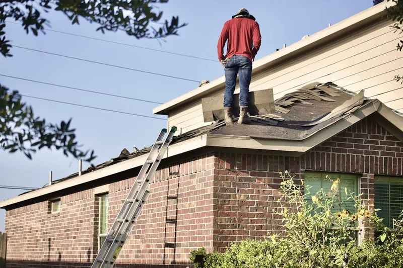 Professional roofer working on a residential roof in Corona Del Mar